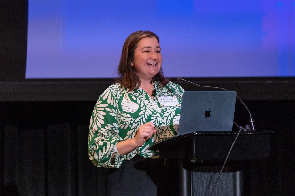 Photograph of Dr. Michele Fugiel Gartner giving her keynote presentation at Bespoke's SPP Speaker Series Event, Women Leading in Social Impact: Why It's Working